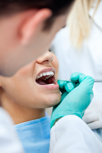 dental with female patient shutterstock_118787944